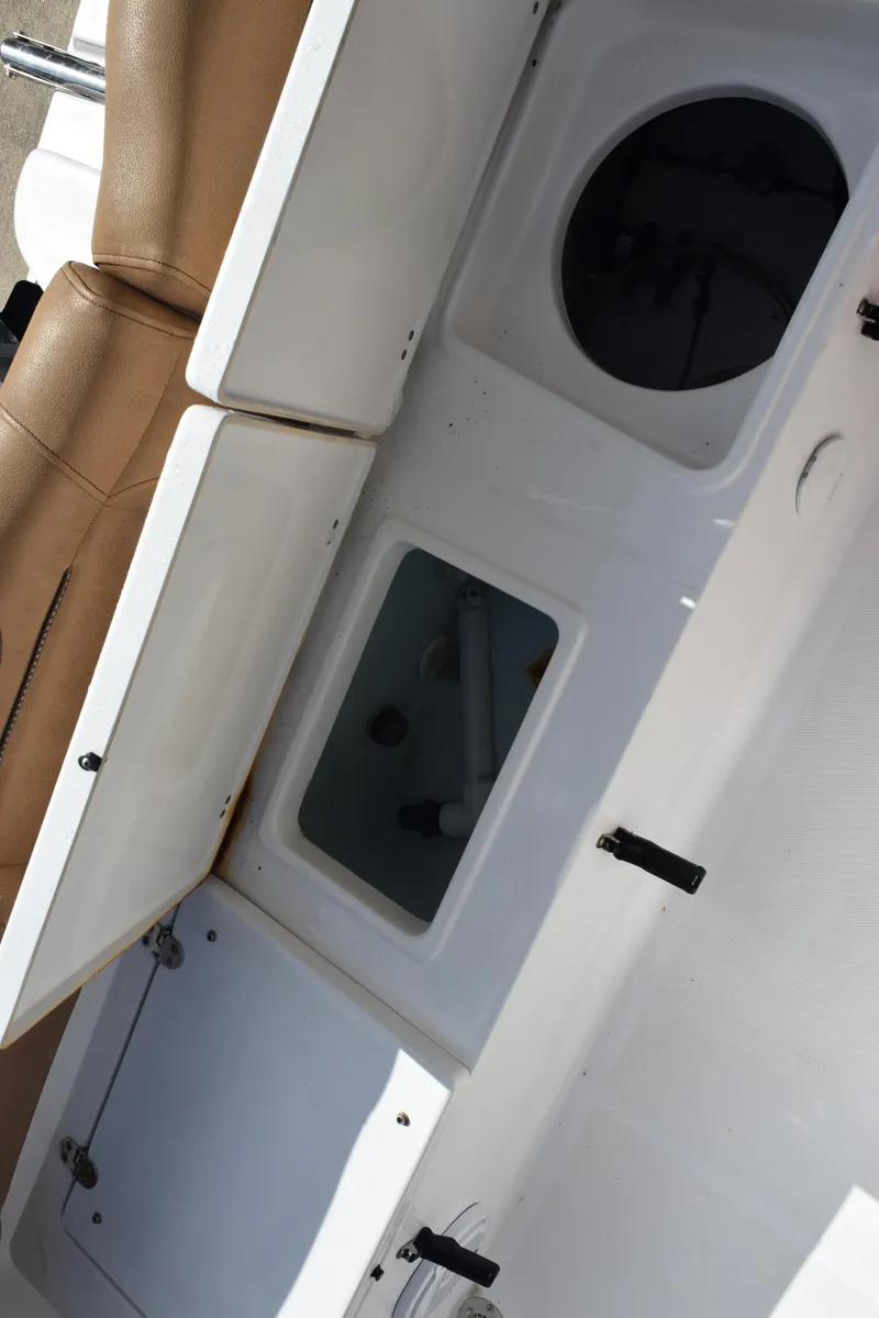 Slide: The Image of 2019 Sea Hunt Ultra 235 SE boat storage compartments and seating detail. - 21