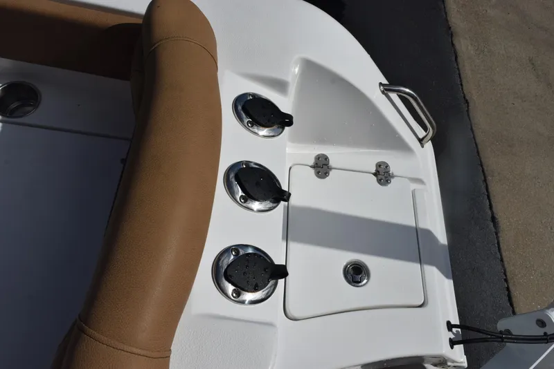 Slide: The Image of 2019 Sea Hunt Ultra 235 SE boat deck with tan seating and utility hatches. - 22