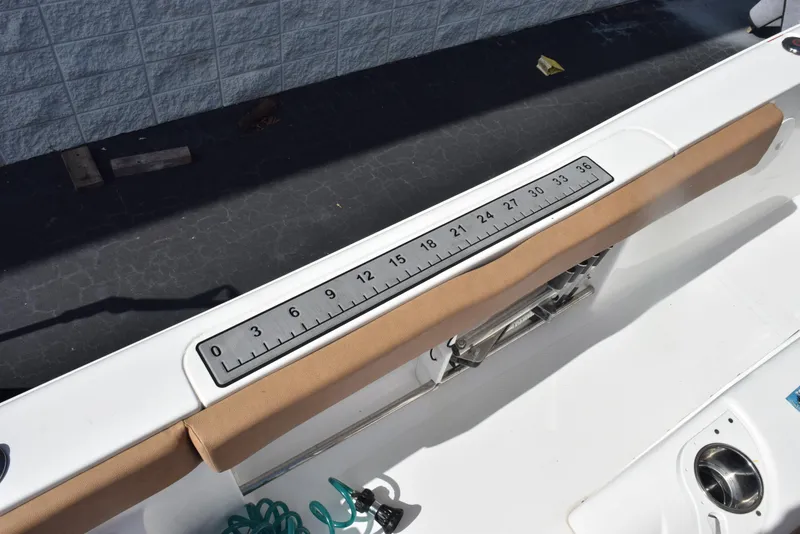 Slide: The Image of 2019 Sea Hunt Ultra 235 SE boat with built-in measuring ruler on deck. - 23