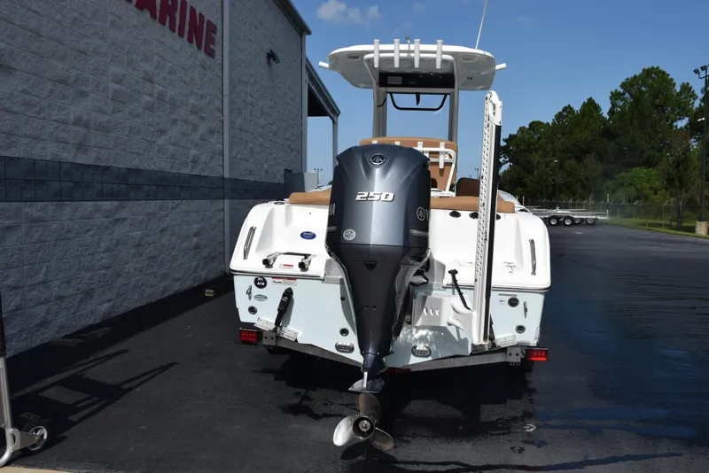 Slide: The Image of 2019 Sea Hunt Ultra 235 SE boat with Yamaha 250 outboard motor, parked outside. - 5