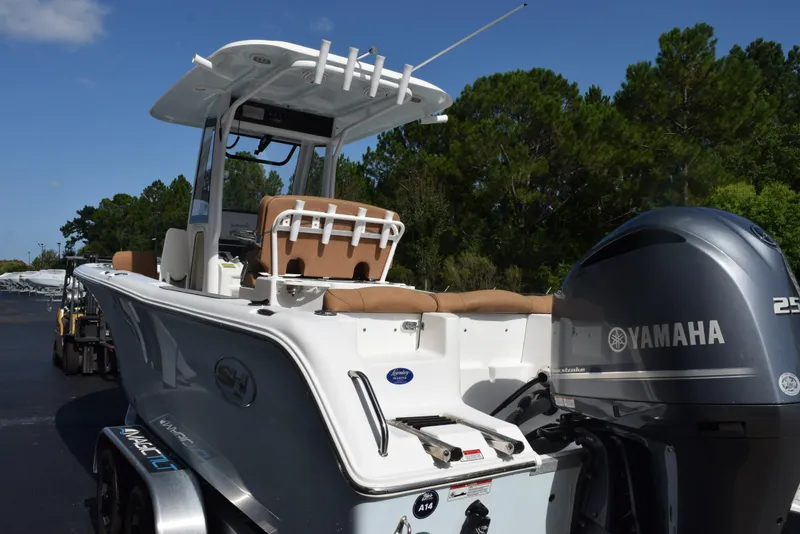 Slide: The Image of 2019 Sea Hunt Ultra 235 SE boat with Yamaha engine, parked outdoors. - 6