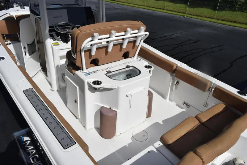 Slide: The Image of 2019 Sea Hunt Ultra 235 SE boat interior with seating and console, featuring Garmin electronics. - 7