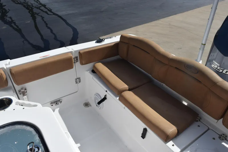 Slide: The Image of 2019 Sea Hunt Ultra 235 SE boat interior with tan seating and Yamaha engine. - 9