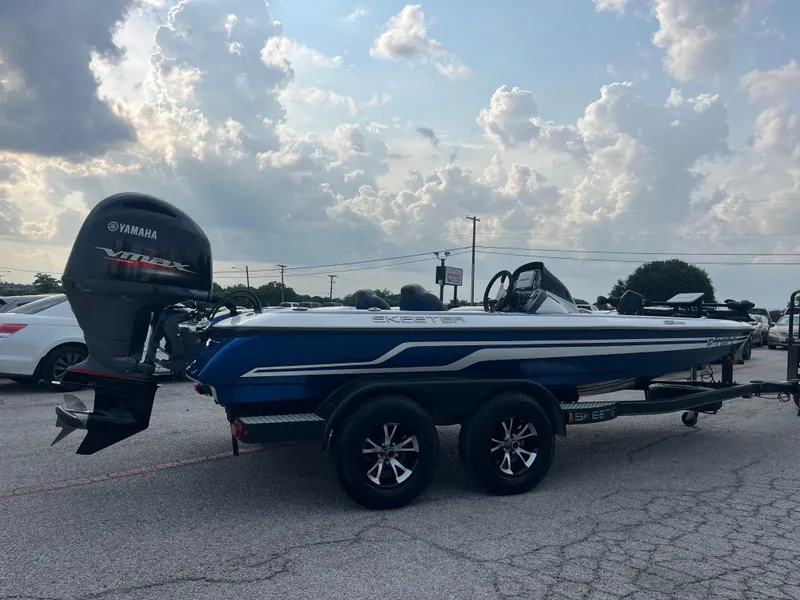 Slide: The Image of 2018 Skeeter ZX190 boat with Yamaha VMAX engine, parked under a cloudy sky. - 12