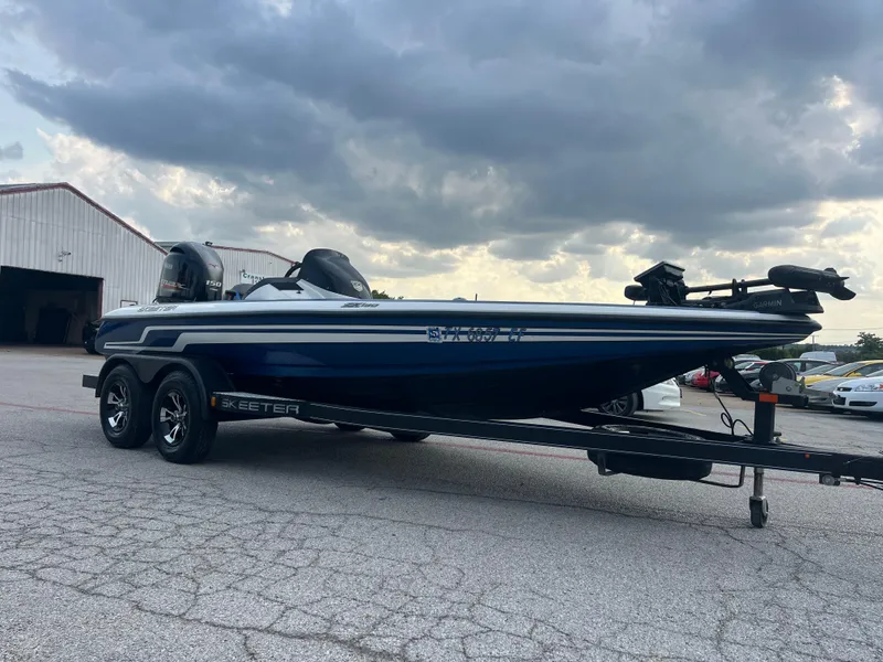 Slide: The Image of 2018 Skeeter ZX190 boat on trailer under cloudy sky. - 13
