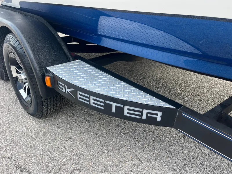 Slide: The Image of 2018 Skeeter ZX190 boat trailer with diamond plate step and logo. - 14