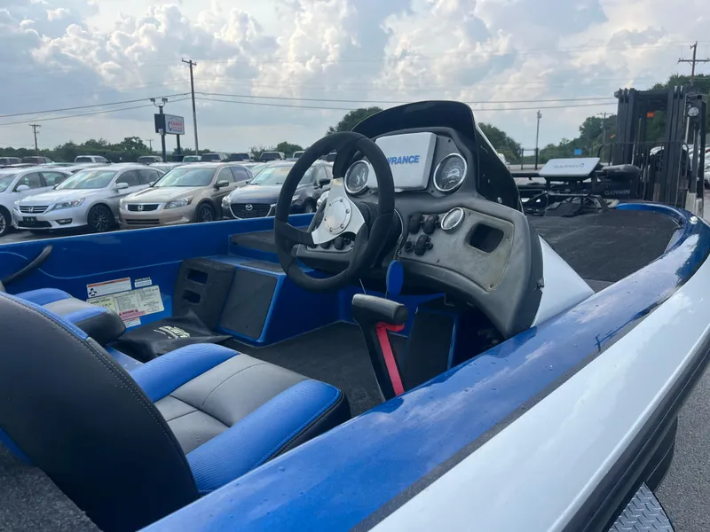 Slide: The Image of 2018 Skeeter ZX190 boat interior with steering wheel and dashboard, parked in a lot. - 16