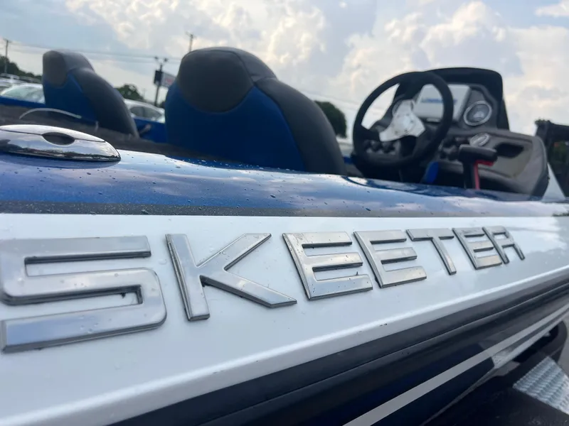 Slide: The Image of 2018 Skeeter ZX190 boat with logo, blue and white design, steering wheel visible. - 18