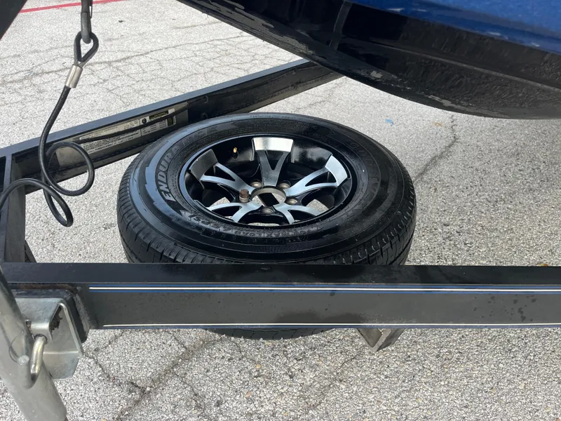 Slide: The Image of Spare tire on a 2018 Skeeter ZX190 boat trailer, parked on asphalt. - 37