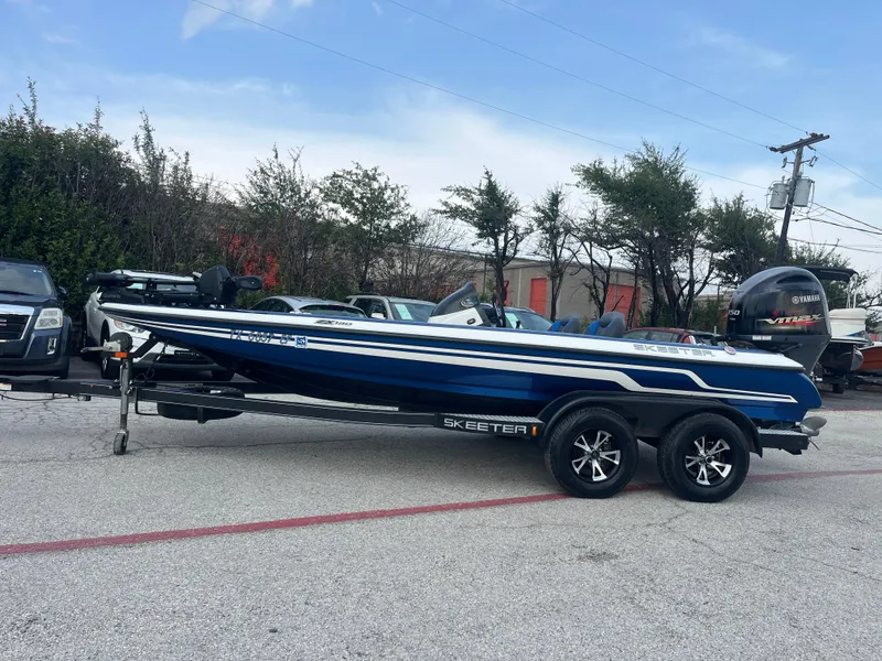 Slide: The Image of 2018 Skeeter ZX190 boat on trailer, parked outdoors with Yamaha VMAX engine. - 4