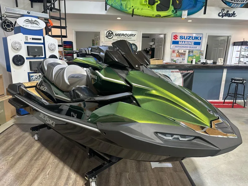 Slide: The Image of 2025 Kawasaki JetSki Ultra 160LX in showroom, featuring sleek green design and advanced features. - 1