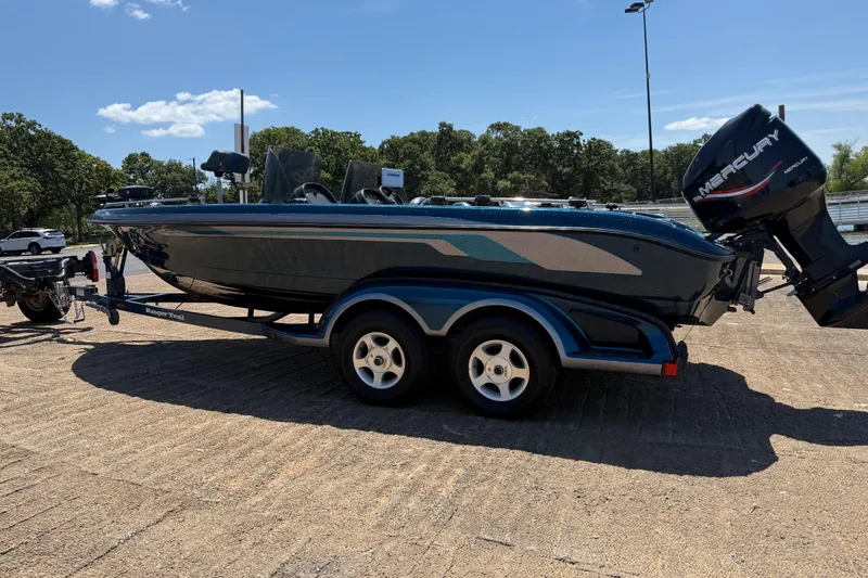 Slide: The Image of 1999 Ranger 620VS Fisherman boat on trailer, parked outdoors under clear sky. - 10