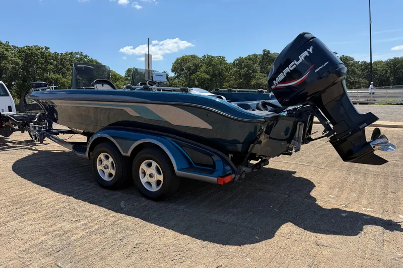 Slide: The Image of 1999 Ranger 620VS Fisherman boat with Mercury engine on trailer, parked outdoors. - 11