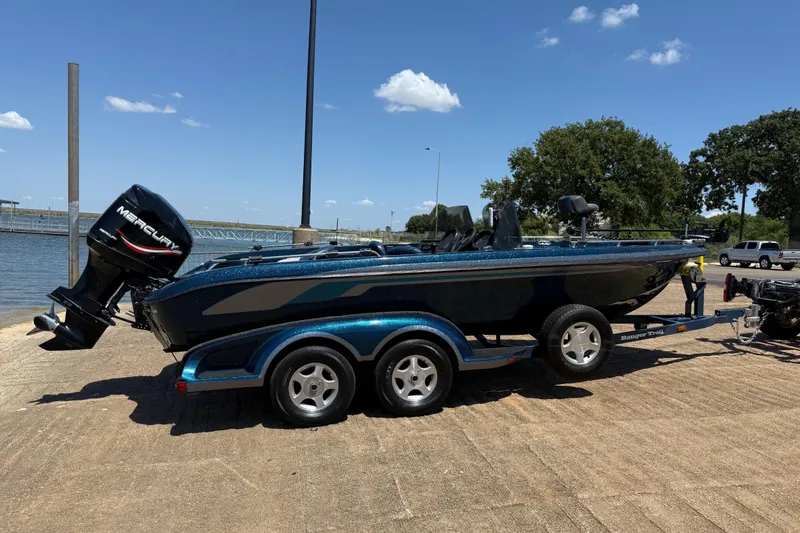 Slide: The Image of 1999 Ranger 620VS Fisherman boat on trailer by the water, sunny day. - 12
