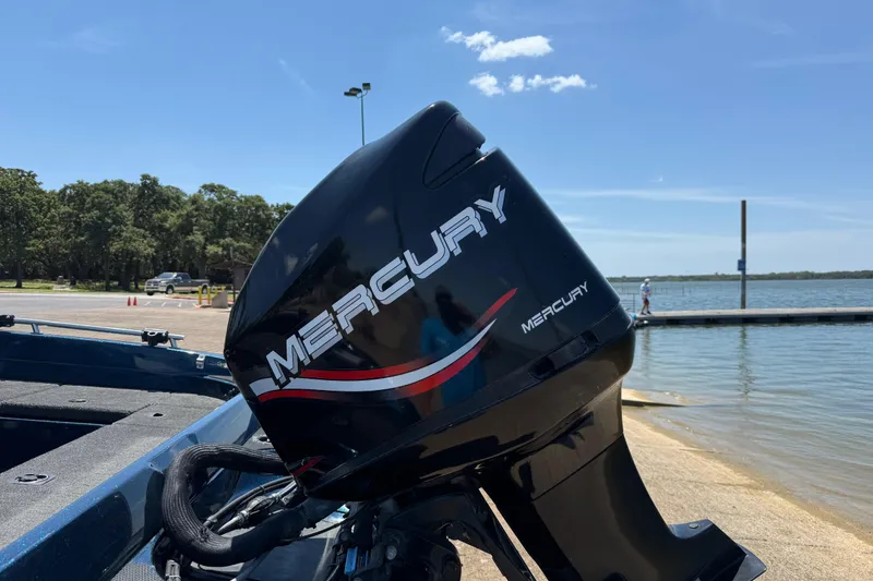 Slide: The Image of 1999 Ranger 620VS Fisherman with Mercury outboard motor at a lakeside dock. - 15