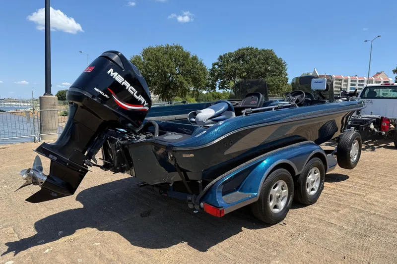 Slide: The Image of 1999 Ranger 620VS Fisherman boat with Mercury outboard motor on a trailer. - 21