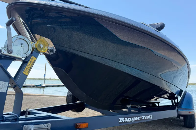 Slide: The Image of 1999 Ranger 620VS Fisherman boat on trailer by the water. - 27
