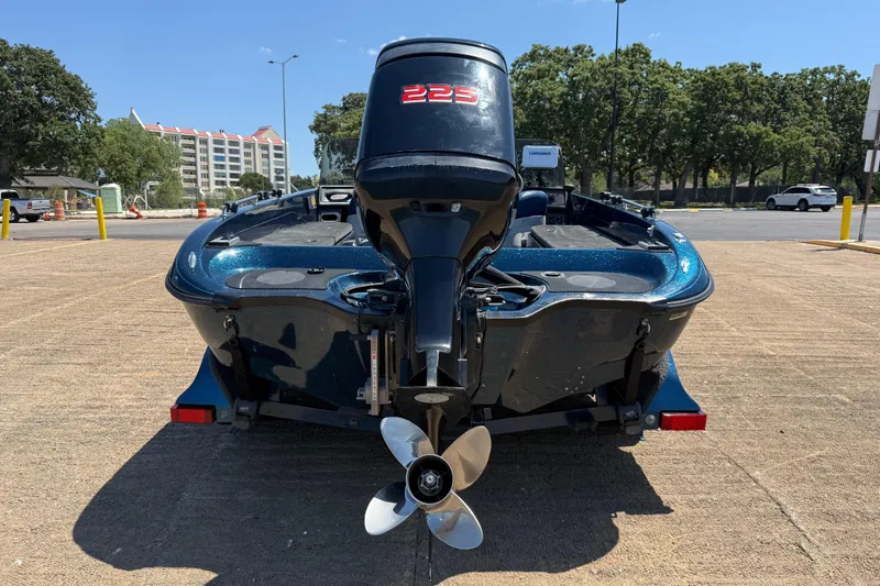 Slide: The Image of 1999 Ranger 620VS Fisherman boat with 225 horsepower motor, parked outdoors. - 3