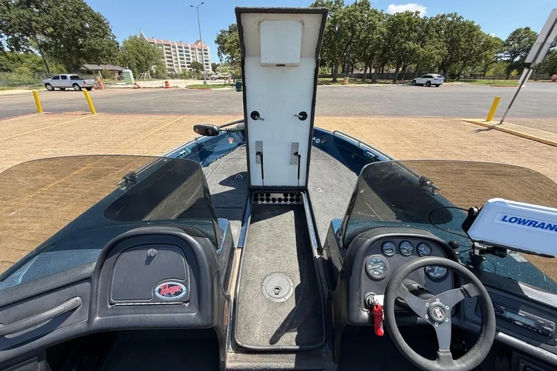 Slide: The Image of 1999 Ranger 620VS Fisherman boat interior with steering wheel and open storage compartment. - 34