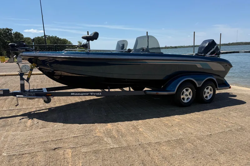 Slide: The Image of 1999 Ranger 620VS Fisherman boat on trailer by a lake. - 4