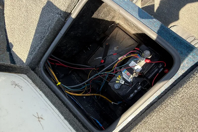 Slide: The Image of Battery compartment of a 1999 Ranger 620VS Fisherman boat with visible wiring. - 42
