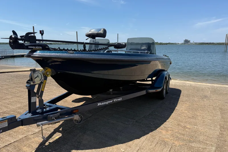 Slide: The Image of 1999 Ranger 620VS Fisherman boat on trailer by the water, featuring Minn Kota motor. - 5