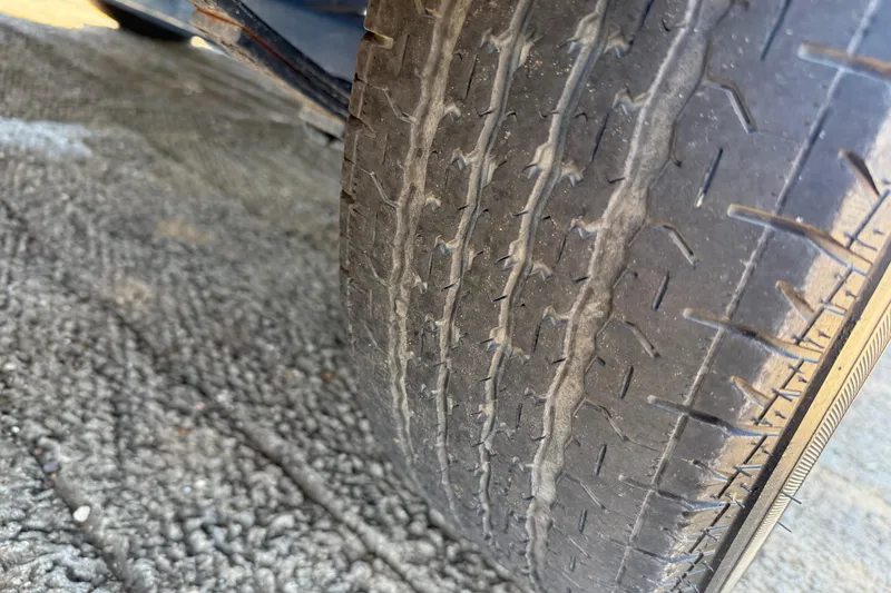 Slide: The Image of Worn tire on a 1999 Ranger 620VS Fisherman, showing tread wear and surface texture. - 55
