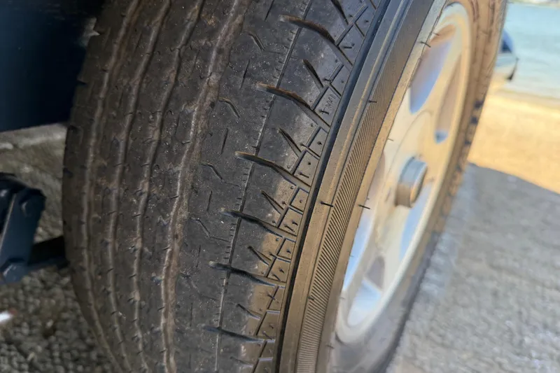 Slide: The Image of Close-up of a 1999 Ranger 620VS Fisherman tire on pavement. - 58