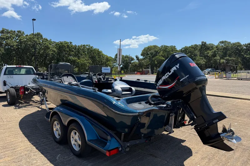Slide: The Image of 1999 Ranger 620VS Fisherman boat with Mercury engine on trailer, parked outdoors. - 8