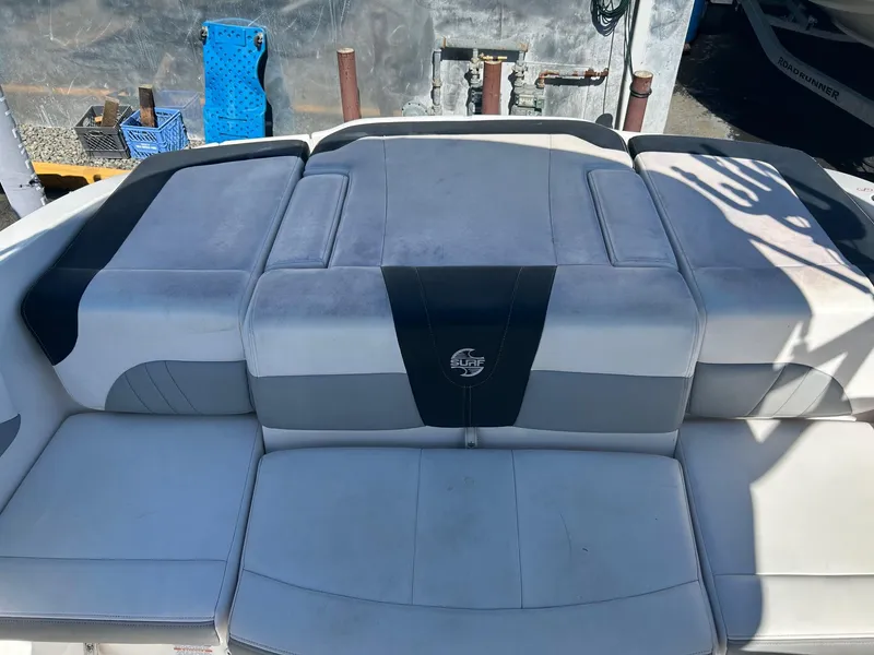 Slide: The Image of 2018 Chaparral 21 H2O Surf boat seating with gray and white upholstery. - 12