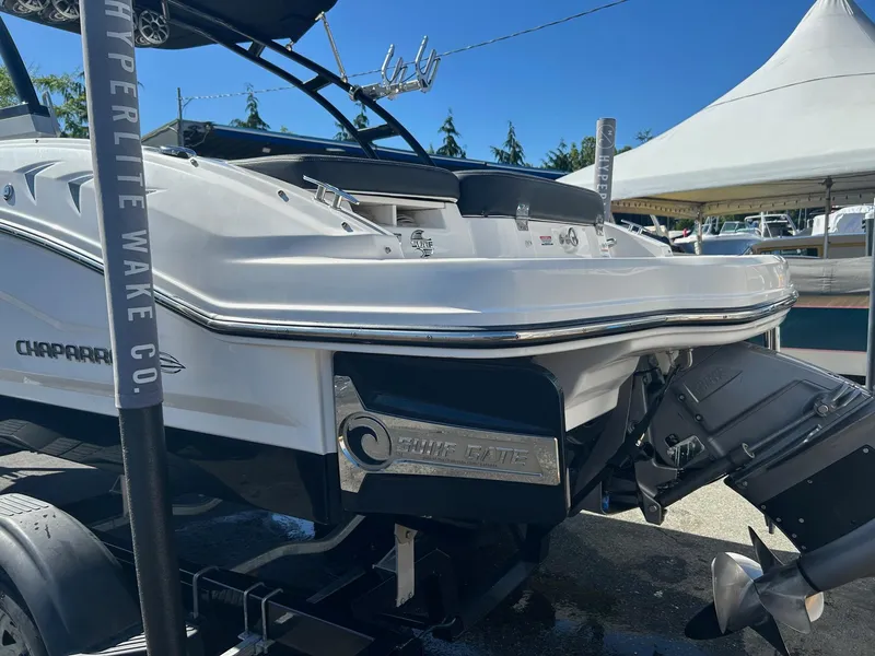 Slide: The Image of 2018 Chaparral 21 H2O Surf boat rear view with propeller and wakeboard tower. - 2