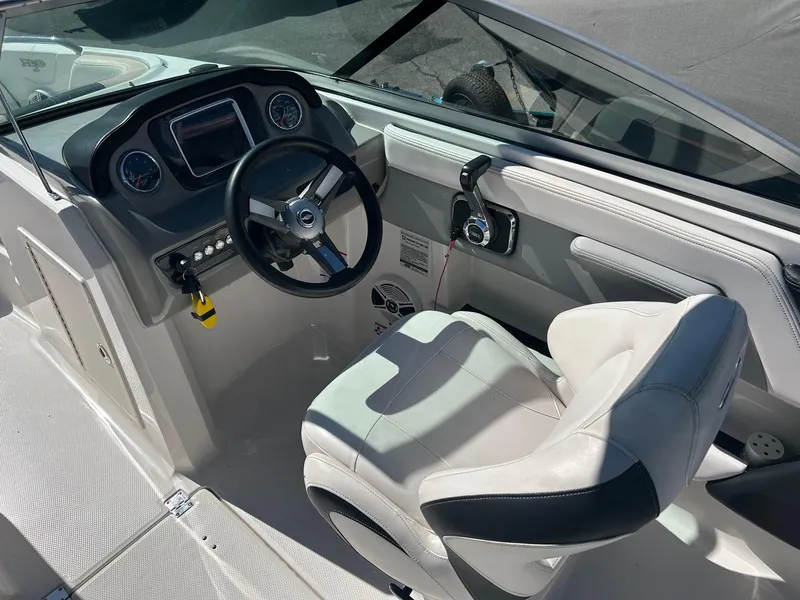 Slide: The Image of 2018 Chaparral 21 H2O Surf boat cockpit with steering wheel and controls. - 4
