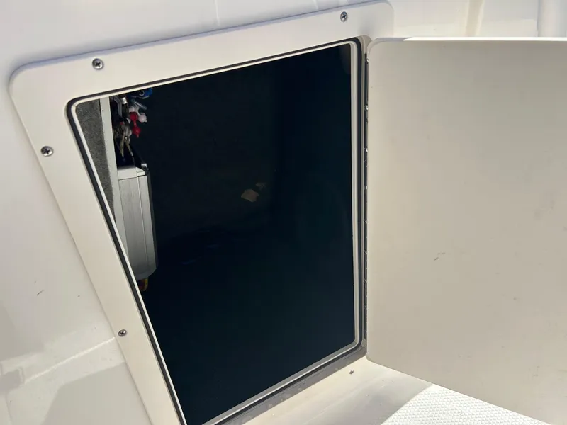 Slide: The Image of Open storage compartment on a 2018 Chaparral 21 H2O Surf boat. - 6