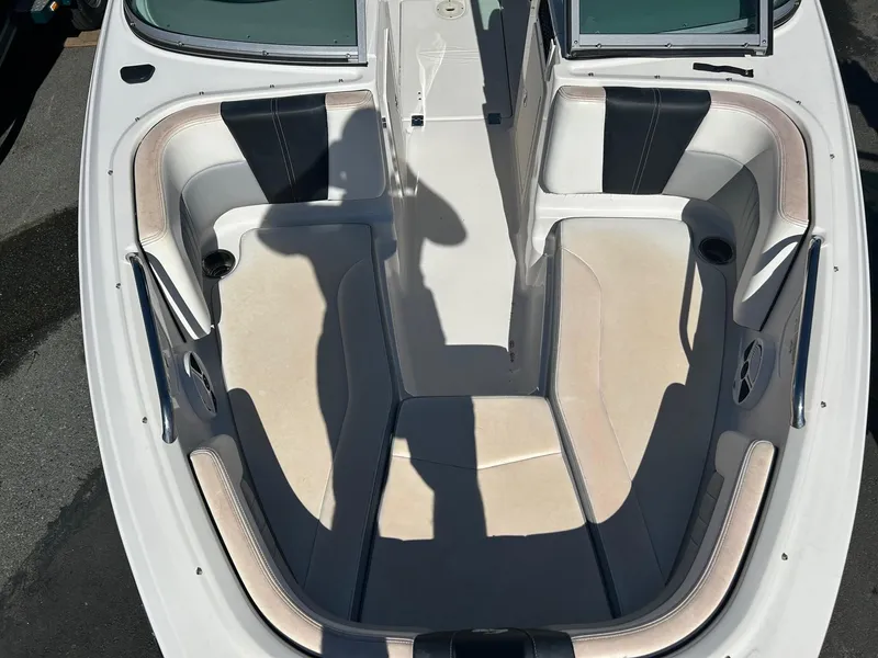 Slide: The Image of 2018 Chaparral 21 H2O Surf boat interior with cushioned seating and open deck. - 9