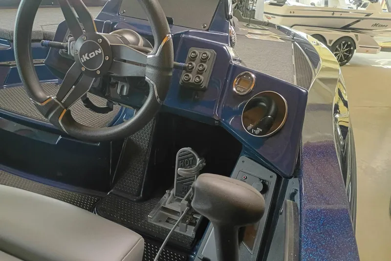 Slide: The Image of Interior of 2026 iKon VLX20 boat, featuring steering wheel and control panel. - 9