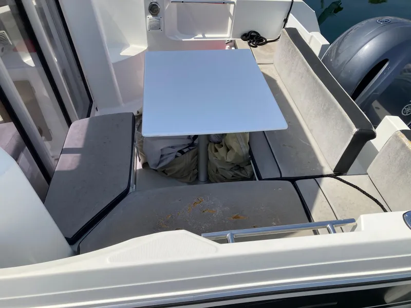 Slide: The Image of 2018 Jeanneau NC 695 boat interior with seating and table setup. - 10
