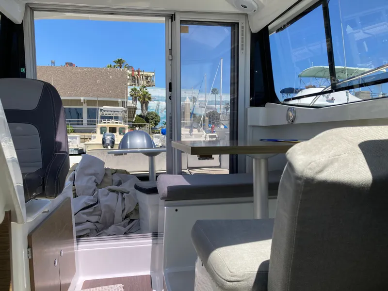Slide: The Image of Interior view of 2018 Jeanneau NC 695 boat with seating and table. - 13