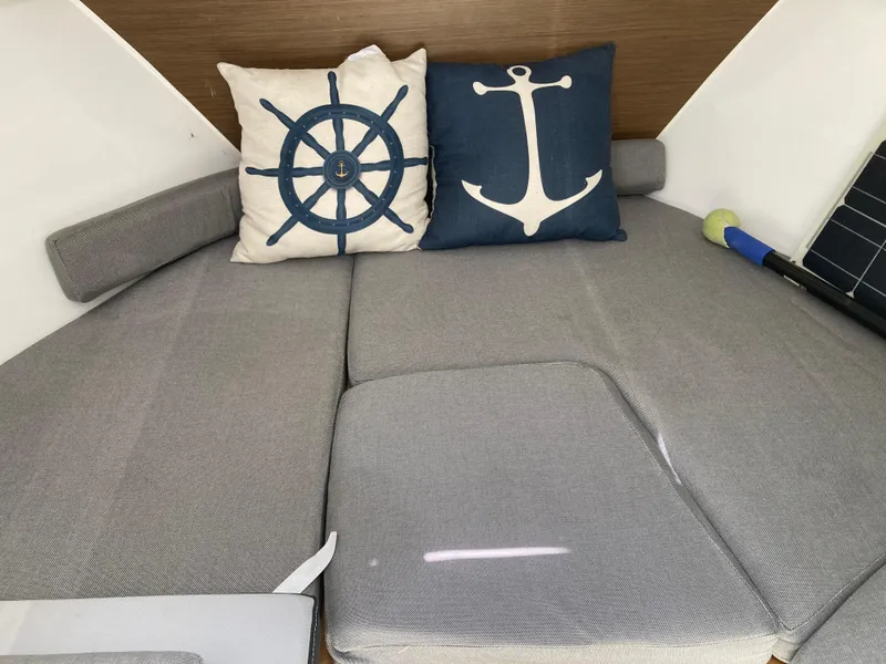 Slide: The Image of Cozy interior of 2018 Jeanneau NC 695 with nautical-themed cushions. - 15
