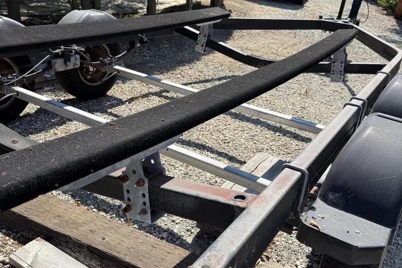 Slide: The Image of Boat trailer for 2018 Jeanneau NC 695 on gravel surface. - 21