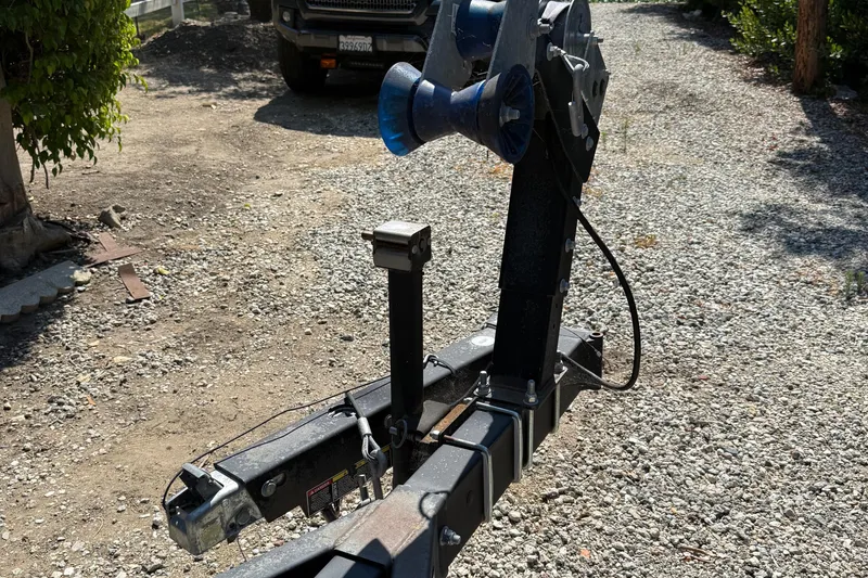 Slide: The Image of Trailer hitch for 2018 Jeanneau NC 695 boat on gravel driveway. - 22