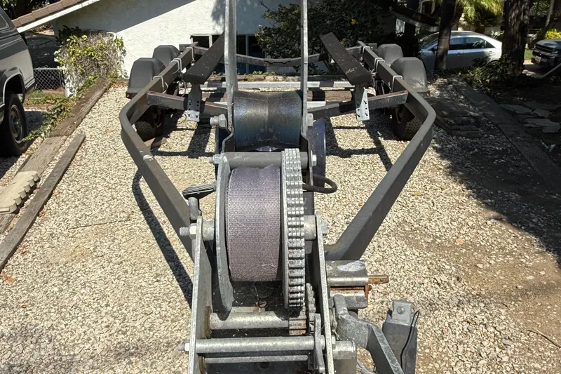 Slide: The Image of Boat trailer for Jeanneau NC 695, 2018 model, parked on gravel driveway. - 23