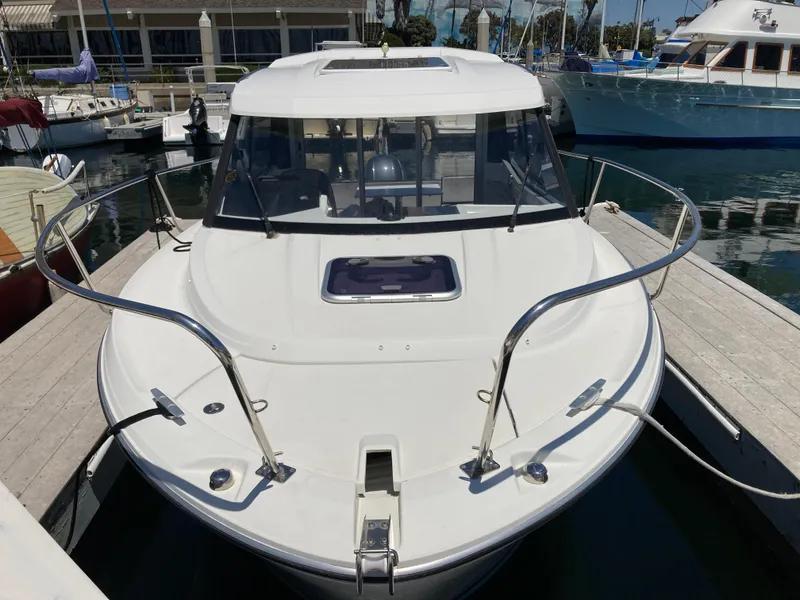 Slide: The Image of 2018 Jeanneau NC 695 boat docked at a marina, front view. - 4