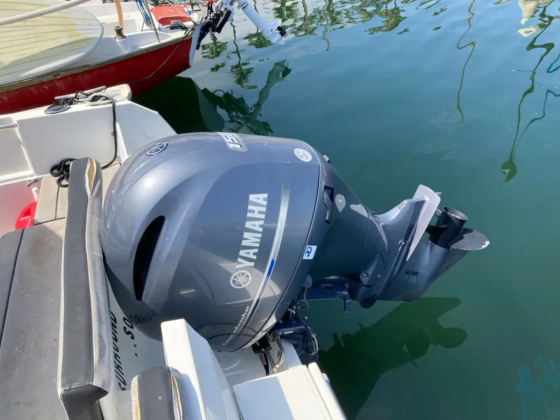 Slide: The Image of Yamaha outboard motor on 2018 Jeanneau NC 695 boat, docked in calm water. - 9