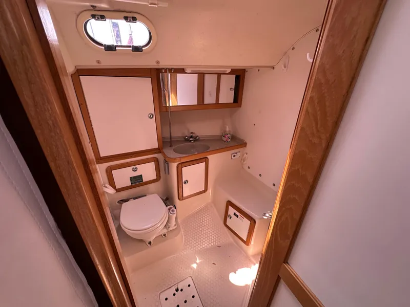 Slide: The Image of 2005 Catalina 36 MkII yacht bathroom with sink, toilet, and storage cabinets. - 11