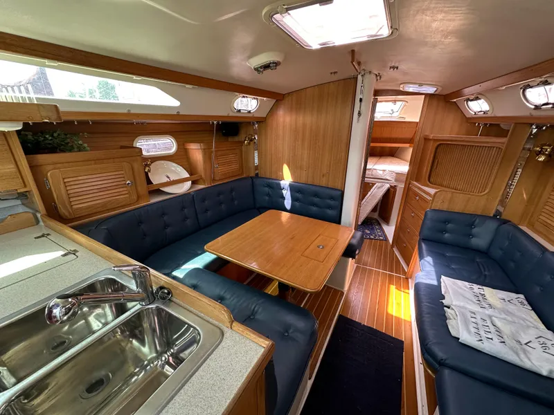Slide: The Image of Interior of 2005 Catalina 36 MkII sailboat with cozy seating and wooden finishes. - 13