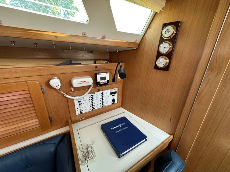 Slide: The Image of Interior of 2005 Catalina 36 MkII sailboat with navigation station and owner's manual. - 14
