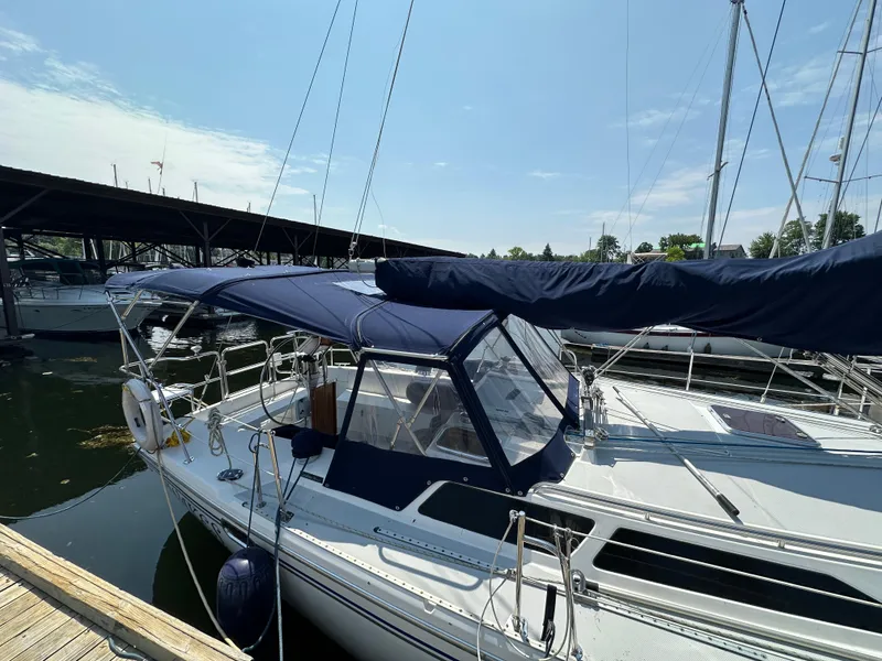 Slide: The Image of Catalina 36 MkII 2005 sailboat docked, featuring blue canvas covers and sleek design. - 15