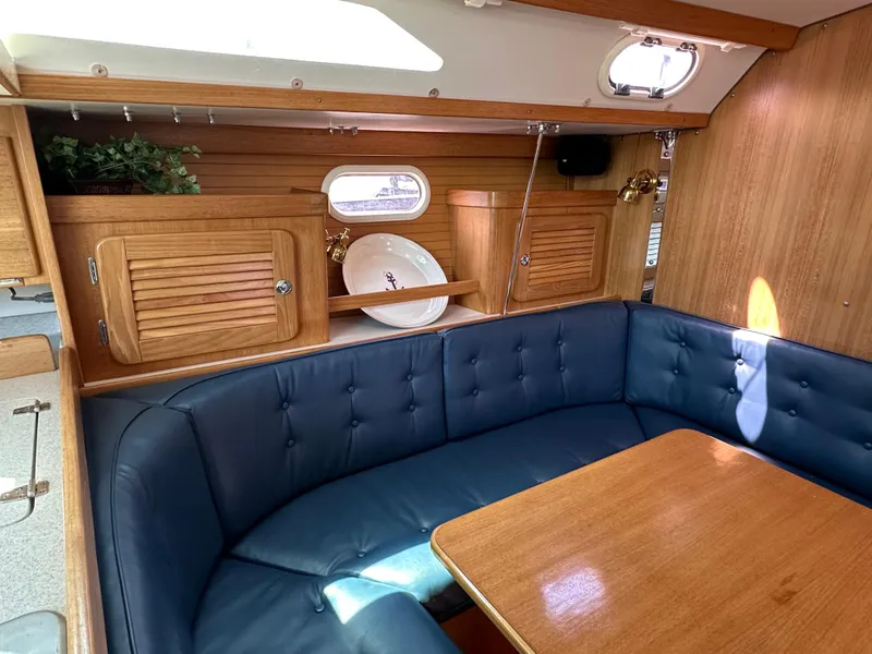Slide: The Image of Interior of 2005 Catalina 36 MkII sailboat with blue seating and wooden cabinetry. - 17