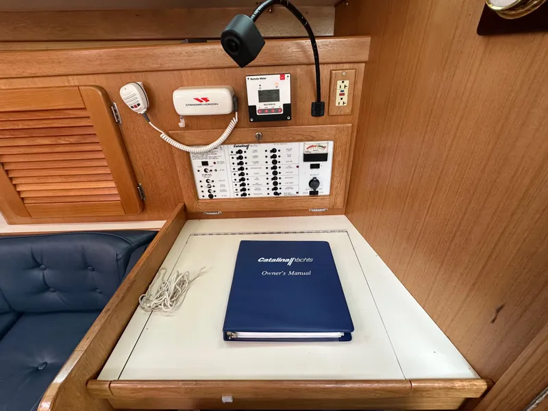 Slide: The Image of Control panel and owner's manual in a 2005 Catalina 36 MkII yacht interior. - 6