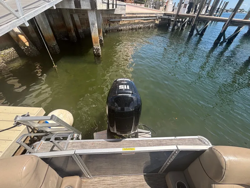 Slide: The Image of 2021 Godfrey Sweetwater boat docked with outboard motor in marina. - 18